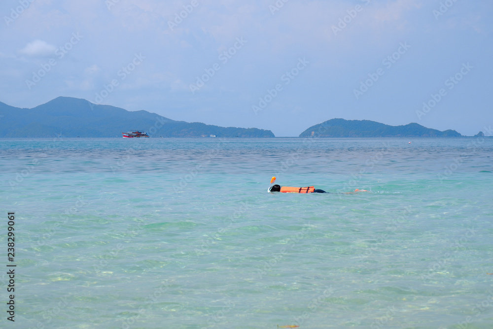 Young woman snorkeling in sea with mask. beautiful sea at Gulf of Thailand