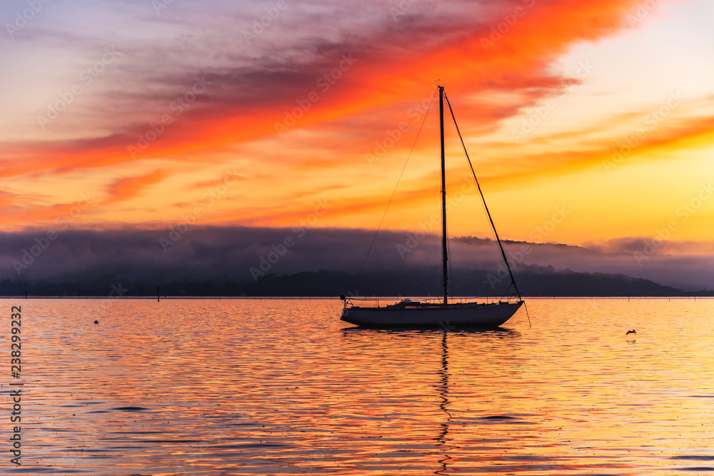 Orange Sunrise and Boat on the Bay