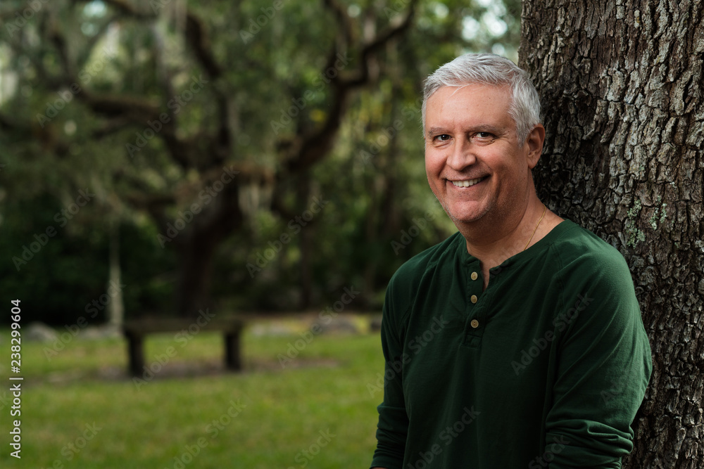 Handsome man outdoors in a park setting