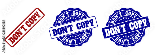 DON'T COPY grunge stamp seals in red and blue colors. Vector DON'T COPY labels with grunge effect. Graphic elements are rounded rectangles, rosettes, circles and text labels.