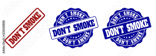 DON'T SMOKE grunge stamp seals in red and blue colors. Vector DON'T SMOKE signs with grunge surface. Graphic elements are rounded rectangles, rosettes, circles and text titles.