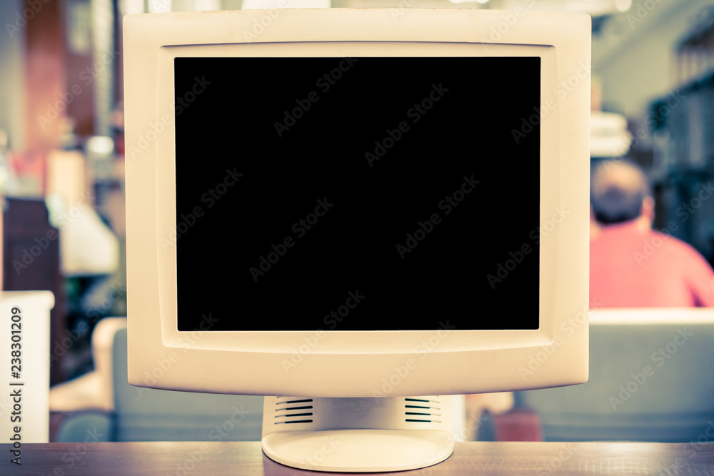 Old CRT computer monitor on 90s office table, blank TV screen display