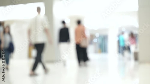 Blurred unidentified patient and medical staff walking in the hospital for background use. Still shot 4K video.
