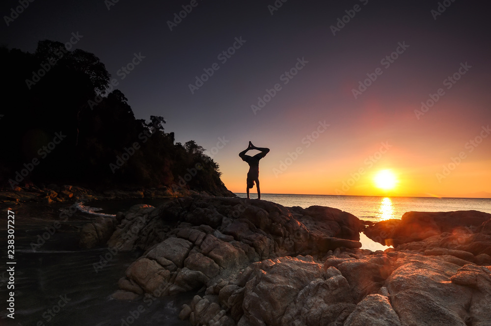 man yoga at sunset
