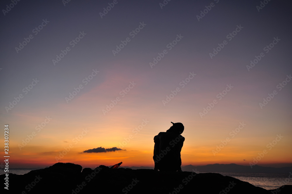 man relex at sea sunset