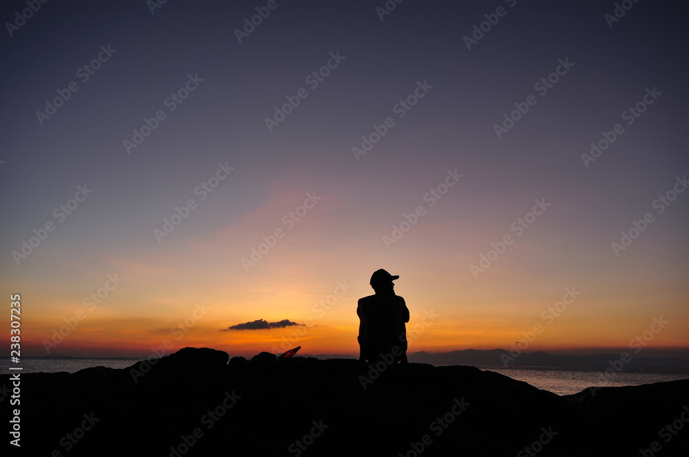 man relex at sea sunset