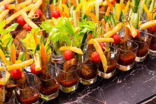 meat snacks with vegetables in a glass cup on a tray © Andrey