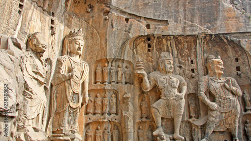 Longmen Grottoes : Massive Buddhist sculptures at main grotto Fengxiansi cave. The world heritage site, Chinese Buddhist art. Located in Louyang, Henan province China. Selective focus. photo