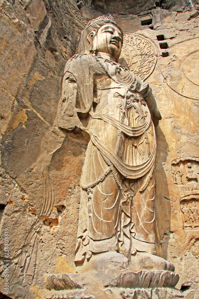Fototapeta premium Longmen Grottoes : The Bodhisattava sculptures of Fengxian Cave (or Li Zhi Cave) The world heritage site, Chinese Buddhist art. Located in Louyang, Henan province China. Selective focus.