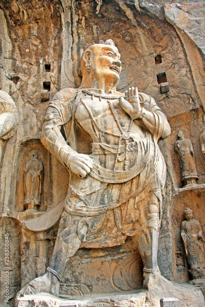 Longmen Grottoes : Massive Buddhist sculptures in the main grotto.The world heritage site, Chinese Buddhist art. Located in Louyang, Henan province China. Selective focus.