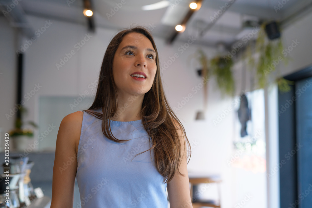 Young happy multi-ethnic businesswoman thinking at the coffee shop Young happy multi-ethnic businesswoman thinking at the coffee shop