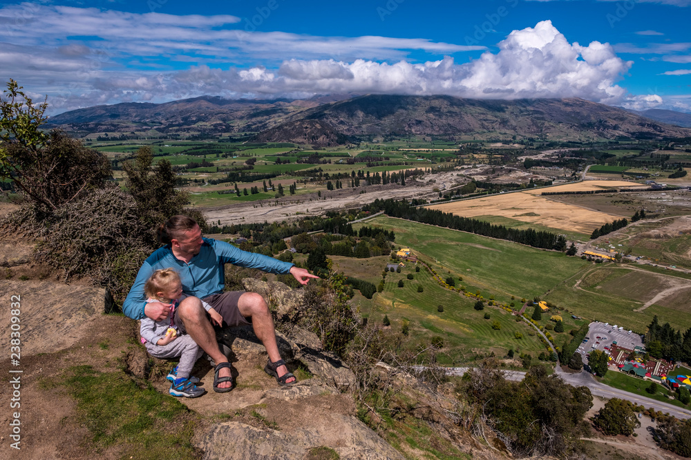 Father with daughter having trekking on Mount Iron. New Zealand