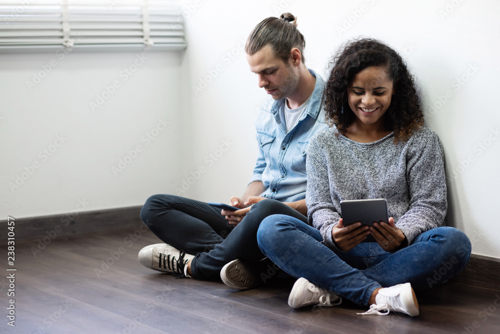Young Couple using smartphone and digital tablet. Young Couple using smartphone and digital tablet.