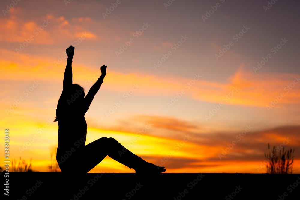 Young woman relaxing in winter sunset sky outdoor.