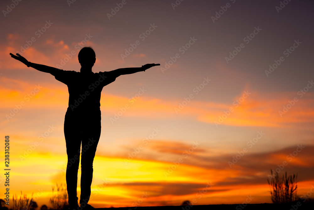 Young woman relaxing in winter sunset sky outdoor.