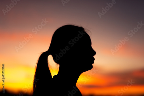 Silhouette face of sad and depressed women of park with sunset