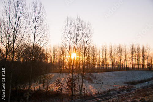 A tiny bit of snow shown during sunrise in a rural Flemish Landscape, on a January morning in 2016