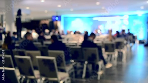 Wallpaper Mural Blurred Background. Many people are sitting in the hall audience listening to presentation lecture speech at forum or conference. Neon lights Torontodigital.ca