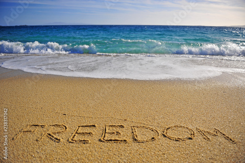 Freedom sign on the sand beach