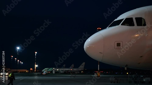 Passenger aircraft on the platform of the night airport. Close-up