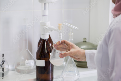 woman testing samples of dairy products in the laboratory. test laboratory of a milk factory