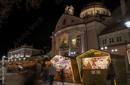 Obraz na plátně Christmas market booth with kurhaus in Merano south tyrol italy,