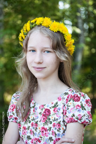 young girl in wreath of dandelions