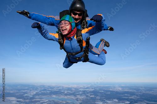 Skydiving. Tandem jump with happy girl.