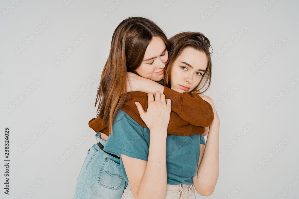 Two sisters twins beautiful girls hipsters in casual clothing on Two sisters twins beautiful girls hipsters in casual clothing on