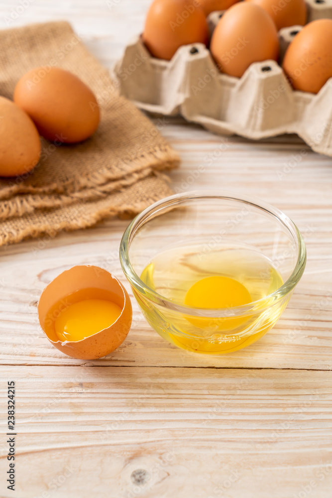 Brown eggs with one broken and egg yolk Brown eggs with one broken and egg yolk