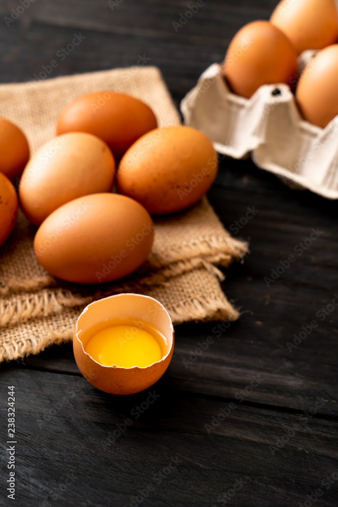 Brown eggs with one broken and egg yolk Brown eggs with one broken and egg yolk