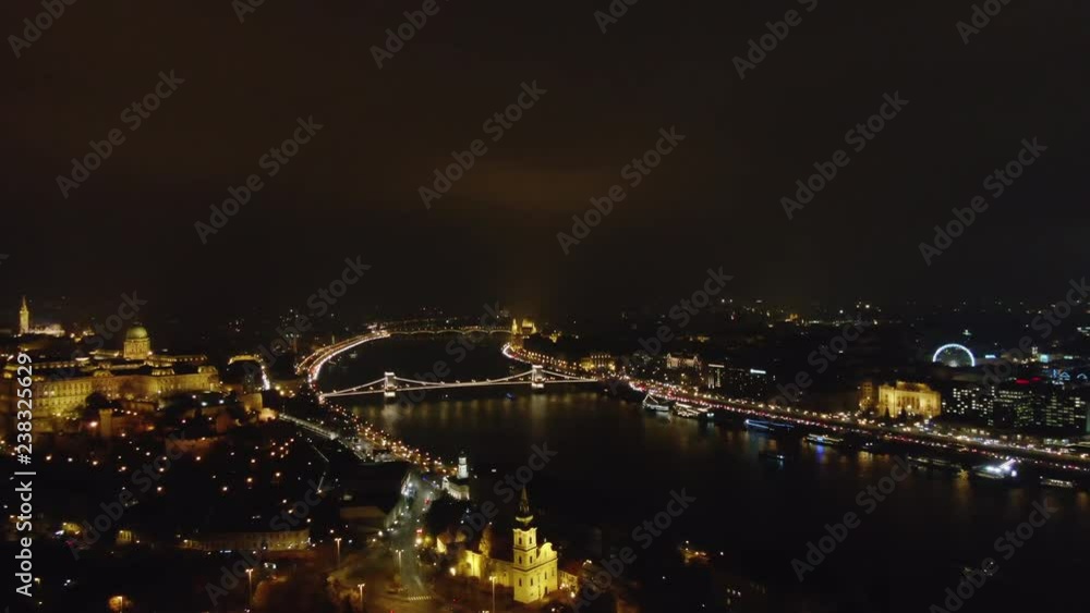 Picturesque drone view of glowing Budapest city with lights reflecting in channel in night time, Hungary Picturesque drone view of glowing Budapest city with lights reflecting in channel in night time, Hungary