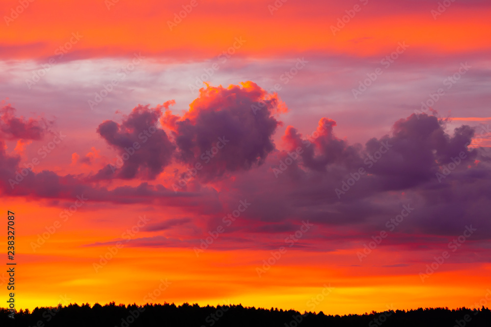 Fototapeta premium Bright morning sky with flaming red, orange and purple clouds