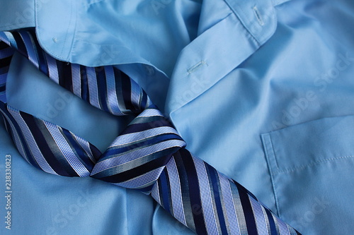On a men`s shirt lies a striped tie