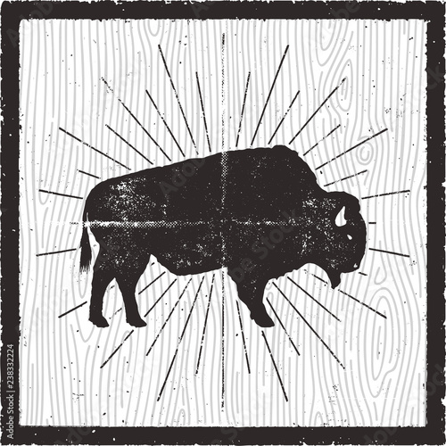 Bison icon silhouette. Retro letterpress effect. Buffalo symbol with sunbursts isolated on retro background card. Use for steak house logo, infographics, logotype. Vector design