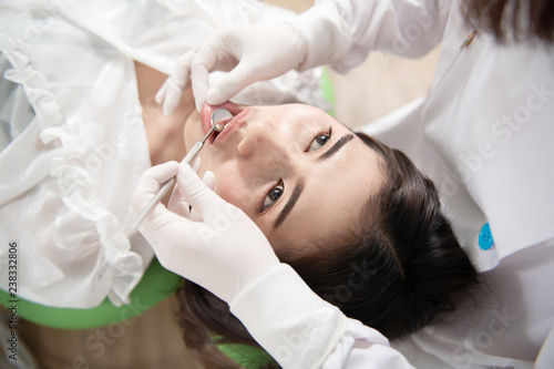 Dentist checking patient woman teeth