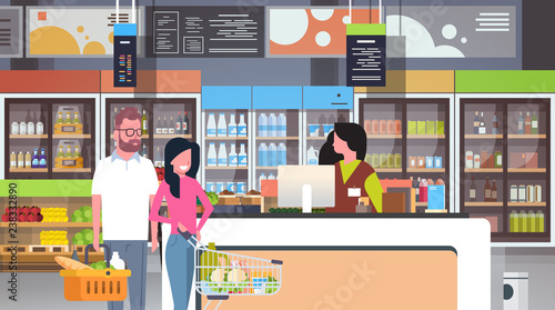 retail woman cashier at checkout supermarket couple customers holding basket with food shopping concept grocery market interior flat horizontal