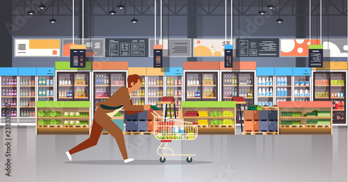 running business man customer with shopping trolley cart busy male shopper buying products grocery market interior flat horizontal