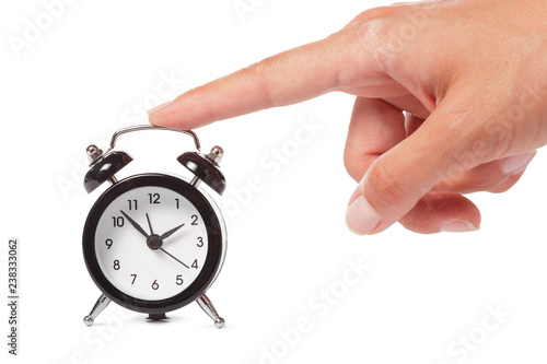 Female hand holding alarm clock on white background