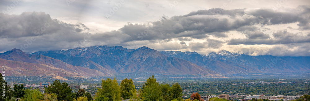 Salt Lake City against mountain and cloudy sky