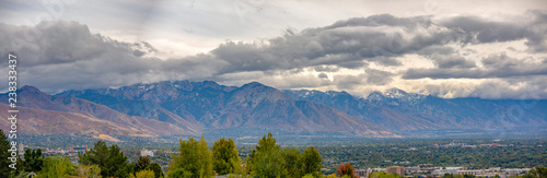 Salt Lake City against mountain and cloudy sky © Jason