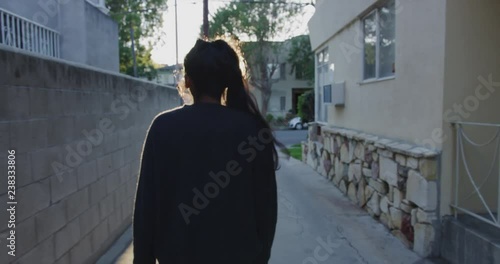 Gimbal shot following a woman through the streets of Los Feliz in Los Angeles, California photo