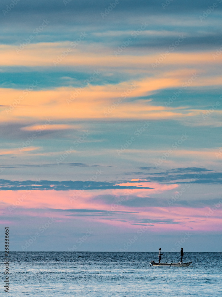 Indonesian fishermen on the horizon with stunning sky backdrop