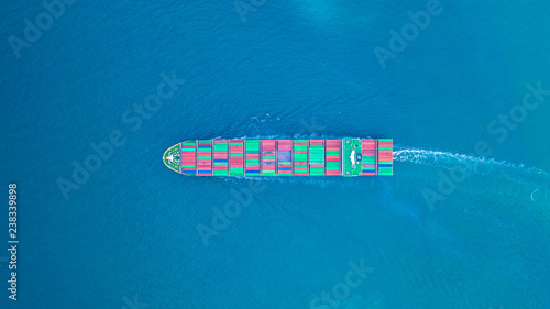 Aerial view cargo container ship carrying container for import and export, business logistic and transportation by ship in open sea.