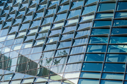 building with reflection in windows of modern building
