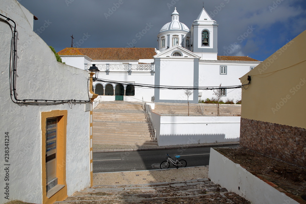The church of the village of Castro Marim, Algarve, Portugal, with whitewashed houses in the foreground