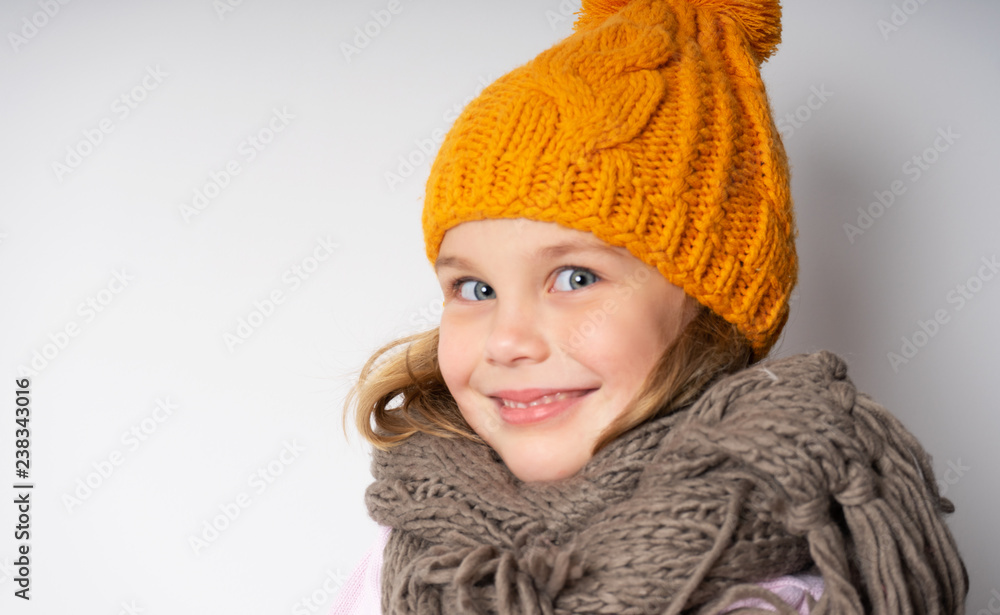 Close up face portrait of toothy smiling young woman wearing knitted pink hat and scarf. A happy smiling woman on a turquoise background in the studio. Copy Space Concept Lifestyle, Winter, Vacation, Close up face portrait of toothy smiling young woman wearing knitted pink hat and scarf. A happy smiling woman on a turquoise background in the studio. Copy Space Concept Lifestyle, Winter, Vacation,