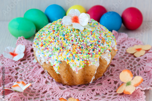 Easter cake on a table on a pink napkin and colorful eggs