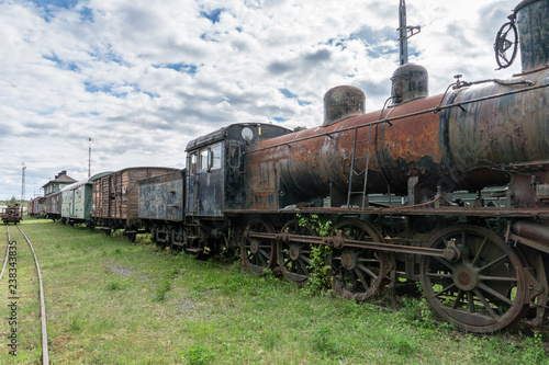Old abandoned steam locomotive with train set