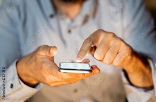 Close up of young man hands using smartphone in Phone Addiction and Mobile Gaming concept